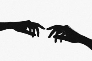Silhouettes of two hands touching